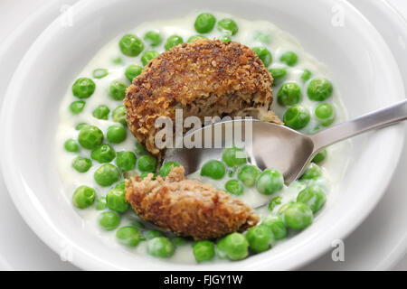 green peas fozelek (thick vegetable stew) and fasirt (fried meatball), hungarian cuisine Stock Photo