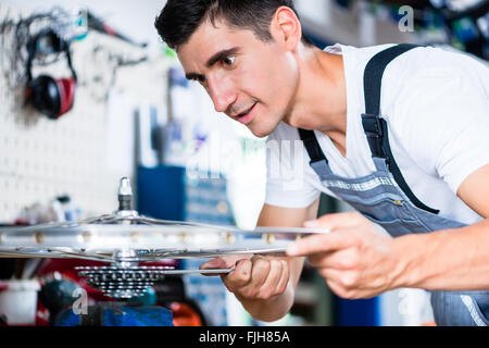 Bicycle mechanic working in his bike workshop Stock Photo