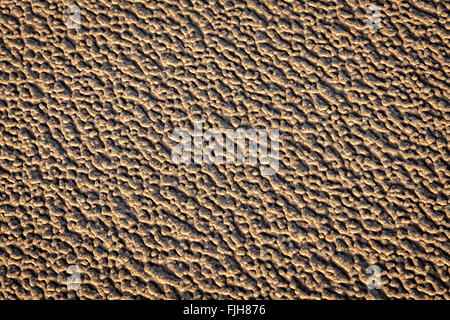 Patterns in beach sand caused by wind and rain. Stock Photo