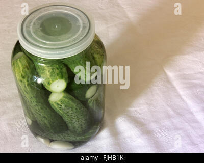Pickled cucumbers. Prepare for canning in big glass jar Stock Photo