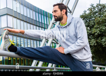 Man stretching doing sport in the city Stock Photo