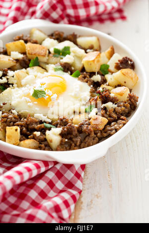 Potato hash with sausage and fried egg Stock Photo