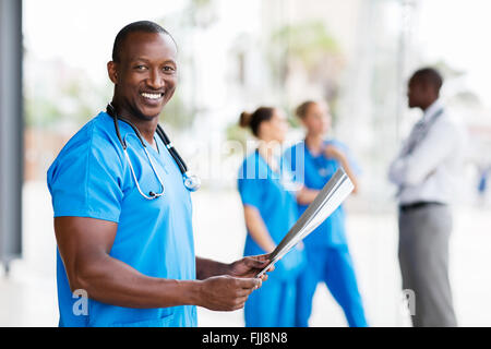 cheerful African American male doctor holding x-ray Stock Photo