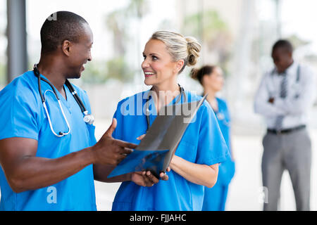 medical doctors discussing over x-ray in hospital Stock Photo