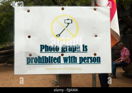'No selfies' sign posted beside Buddha images at Polonnaruwa, Sri Lanka Stock Photo