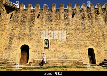 Man in white in front of the old Church of Our Lady Mary of Zion in Axum (or Aksum), Tigray Region, Ethiopia Stock Photo