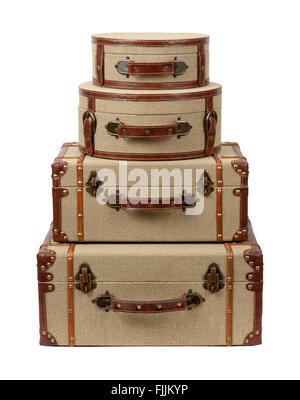 Four Stacked Deco Burlap Suitcases. The image is a cut out, isolated on a white background. Stock Photo