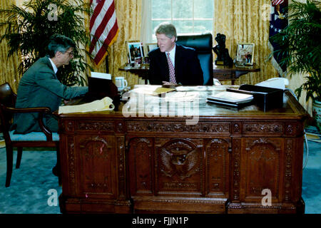 Washington, DC., USA, 24rd January, 1993 President William Clinton sits at his desk in the Oval Office as he works with Robert Rubin the Chairman of the Economic Council drafting the speech that he will deliver tomorrow on his economic polices  Credit: Mark Reinstein Stock Photo