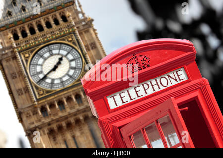 Traditional red telephone box with Big Ben out of focus in the background. Stock Photo