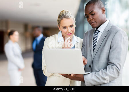 multiracial businesspeople using laptop computer in office Stock Photo