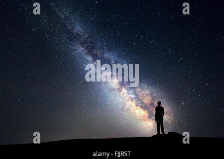 Night sky with stars and silhouette of a standing man Stock Photo - Alamy