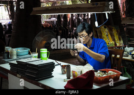 Victims of Agent Orange working at the Nam Quoc Lacquerware Factory in the suburbs of Ho Chi Minh City Stock Photo