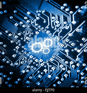 Gears icon on computer chip Stock Photo