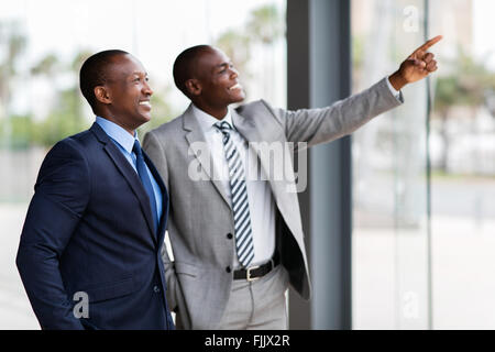 happy African business men pointing in modern office Stock Photo