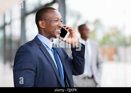 cheerful black businessman talking on cell phone Stock Photo