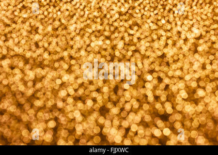 Colourful spark and glow colourful shining bokeh light in golden colour tone for abstract background Stock Photo