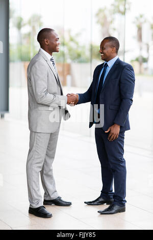 successful African businessmen handshaking in conference hall Stock Photo