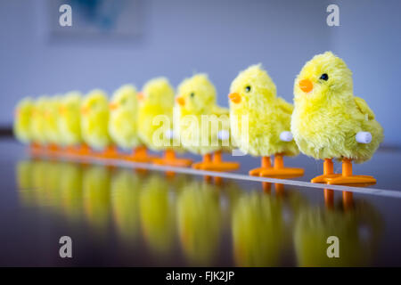 A row of wind-up toy baby chicks. Stock Photo