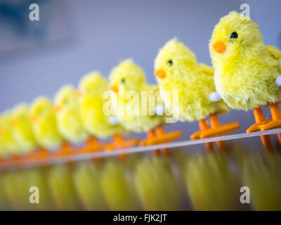 A row of wind-up toy baby chicks. Stock Photo