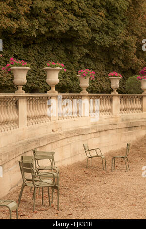 Classical stone urns, balustrades and chairs at Luxembourg Garden, Paris, France Stock Photo