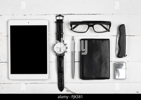 Business still-life with tablet computer glasses and cigarette lighter on white boards Stock Photo