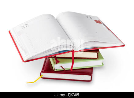 Stack of notebooks with red open top isolated on white background Stock Photo