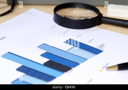 Financial graphs analysis and pen. Stock Photo