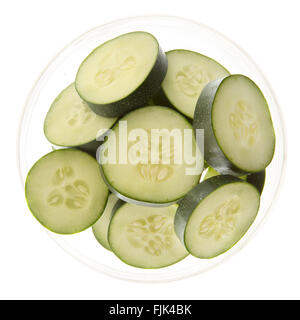 Slices of fresh cucumbers in a bowl and isolated on white. Stock Photo