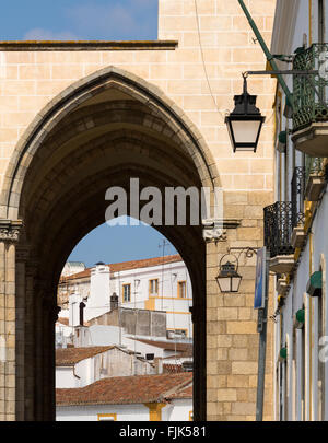 Typical architecture and view of town through archway, Evora, Alentejo region, Portugal Stock Photo