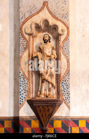 Interior detail wood carving a of religious icon in the historic Mission San Xavier del Bac, Tucson, Arizona. Typical Spanish colonial devotional art. Stock Photo