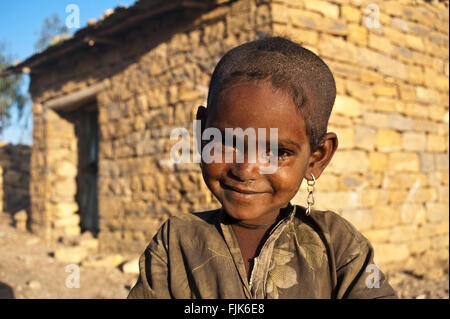 Girl belonging to the Agaw people. She is standing in front of the house her parents are renting with two other families. Stock Photo