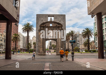 People walking on Sarandi pedestrian street, in the Ciudad Vieja area with the landmark Citadel Gate Stock Photo