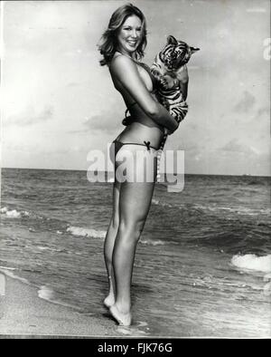 1975 - Hold that tiger. Shapely Patti Mac likes to live dangerously and nursing a frisky Bengal tiger cub is for her all part of the fun of living. Patti who is seen at Miami Beach, borrowed the tiger cub from a friend who runs a local zoo. Patti says the cub is as gentle as a lamb - at the moment. © Keystone Pictures USA/ZUMAPRESS.com/Alamy Live News Stock Photo