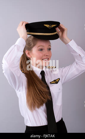 Attractive young female airline pilot in uniform Stock Photo - Alamy