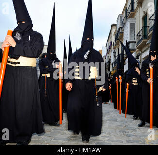 Processions of Nazarenos walk the streets at night during Semana Santa in Malaga, Spain. Stock Photo