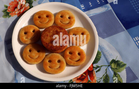 Snack made with potato - fried potato as smile shape ; a popular Indian snack. Stock Photo