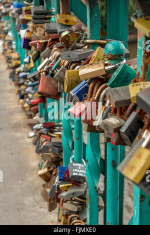Locks of love on bridge railings Stock Photo