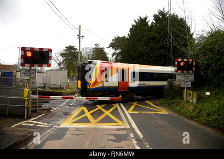 Railway level crossing with the barriers down, UK Stock Photo