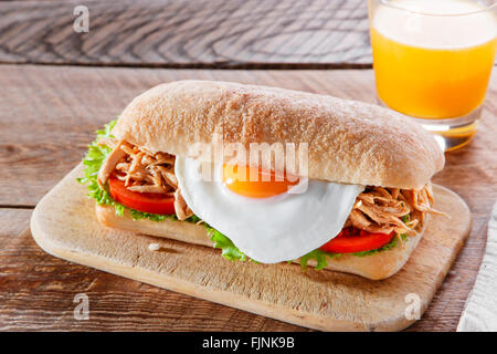 Sandwich with grilled meat egg tomato salad ciabatta Stock Photo