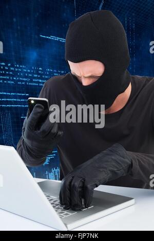 Thief taking picture document on laptop Stock Photo