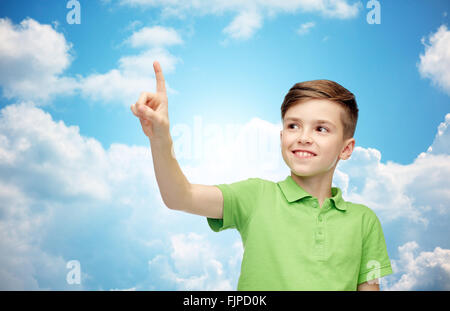 happy boy in green polo t-shirt pointing finger up Stock Photo