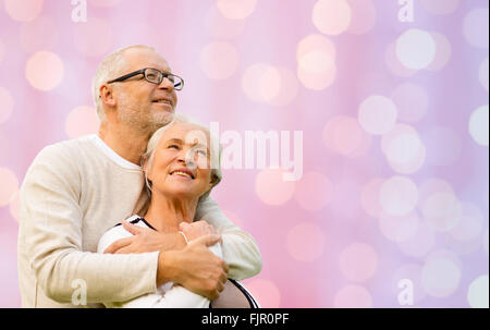 happy senior couple hugging over lights background Stock Photo