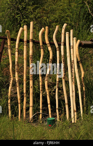 Walking sticks, canes, for sale buy honesty box on mountain footpath, Drakensberg Park South Africa. Stock Photo