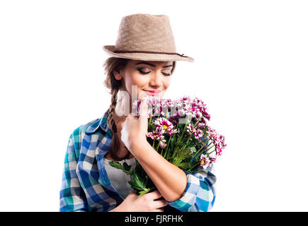 Woman in checked shirt holding bouquet of chrysanthemum flowers Stock Photo