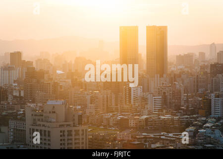 View of buildings in haze at sunset, from Elephant Mountain, in Taipei, Taiwan. Stock Photo