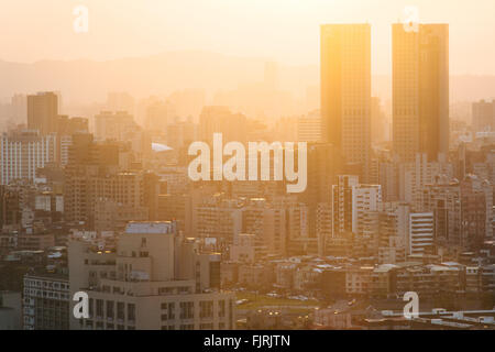 View of buildings in haze at sunset, from Elephant Mountain, in Taipei, Taiwan. Stock Photo