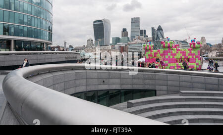 London, UK.  3 March 2016.  Members of the public enjoy playing on a jelly-themed bouncy castle erected outside City Hall at More London.  Open to adults only, the three day event celebrates the launch of a new mobile-phone game called 'Candy Crush Jelly Saga'. Credit:  Stephen Chung / Alamy Live News Stock Photo