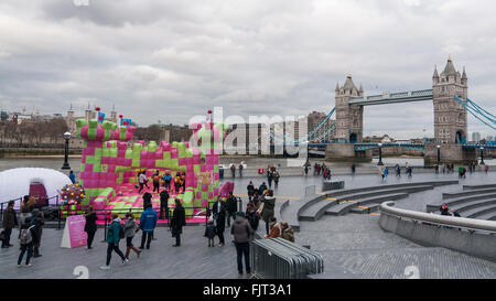 London, UK.  3 March 2016.  Members of the public enjoy playing on a jelly-themed bouncy castle erected outside City Hall at More London.  Open to adults only, the three day event celebrates the launch of a new mobile-phone game called 'Candy Crush Jelly Saga'. Credit:  Stephen Chung / Alamy Live News Stock Photo