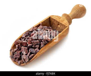 Cacao nibs in wooden showel isolated on white background Stock Photo