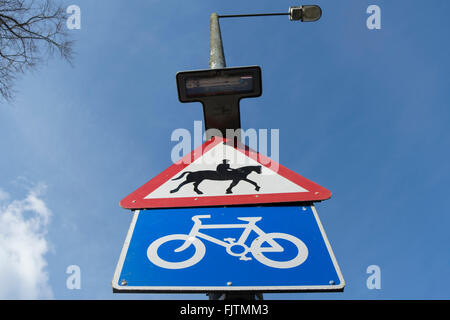 british road signs indicating a cycle route and warning drivers of the presence of horse riders Stock Photo